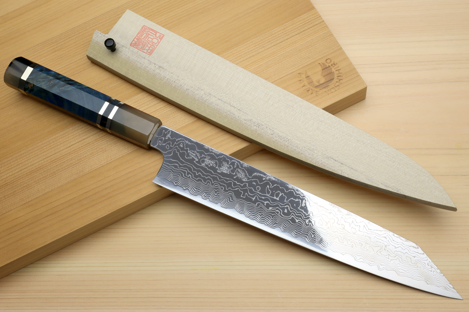 Utility-Kiritsuke chef knife with ocean-blue handle resting on wooden display box