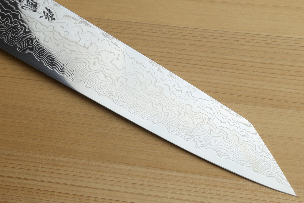 Utility-Kiritsuke chef knife blade in profile, light damascus lines and sharp tip