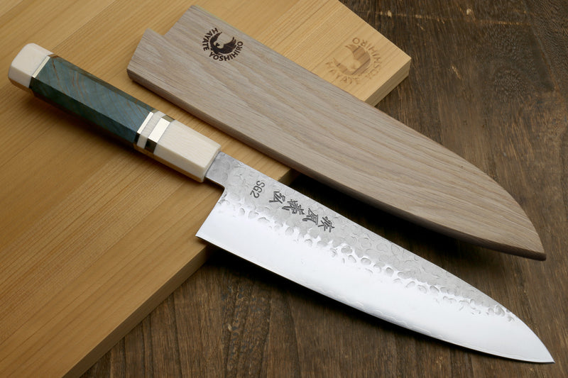 Hammered stainless gyuto knife with ocean blue handle, angled view