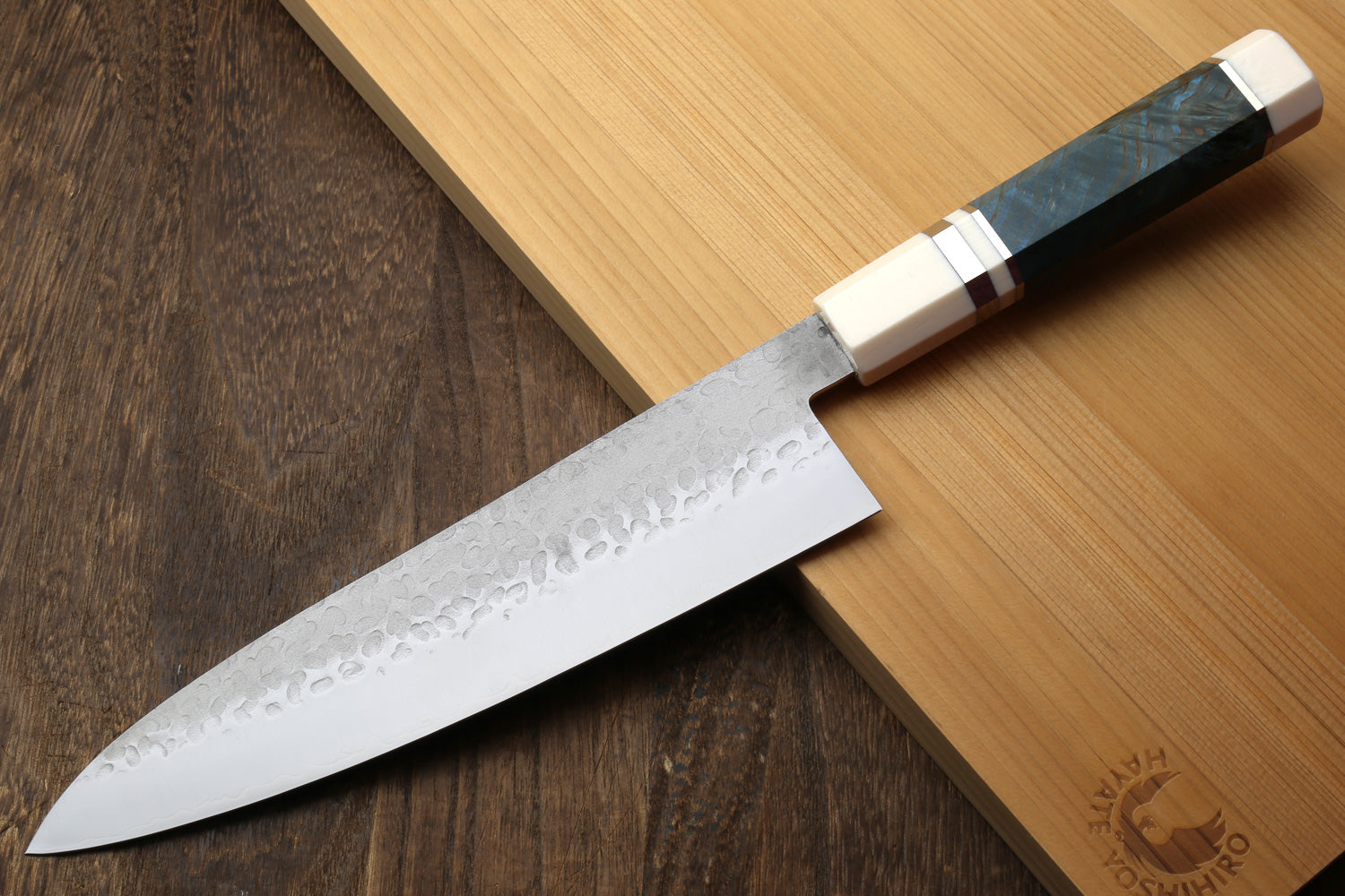 8.5 in hammered steel gyuto knife with silver blade and ocean blue stabilized handle