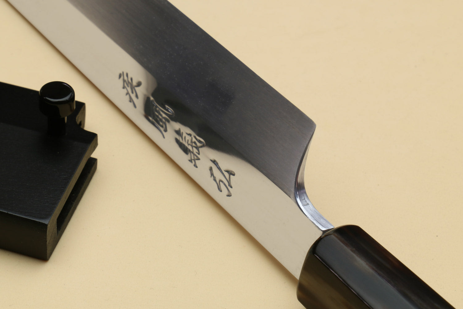 Yanagi sashimi knife with engraved blade and dark triple-ring ebony handle