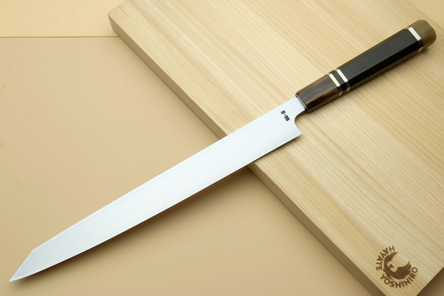 Yanagi kiritsuke knife with mirror-polished blade and dark ebony handle