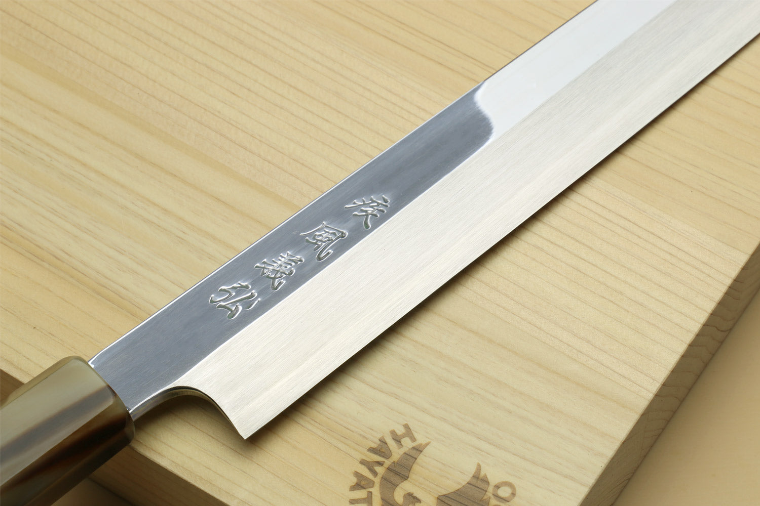 Yanagi kiritsuke knife blade with engraved marks and dark ebony handle
