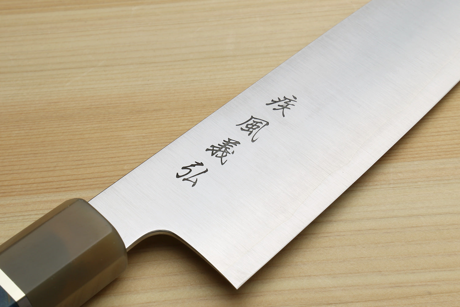 Stainless steel gyuto chef knife blade with engraved markings