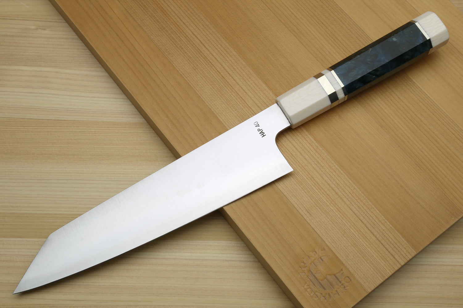 Kiritsuke chef's knife with stainless steel blade, ocean blue handle scales, and ivory bolster