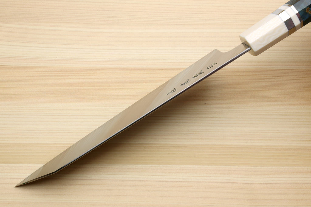 Kiritsuke chef's knife with stainless steel blade and white handle with checkered spacer