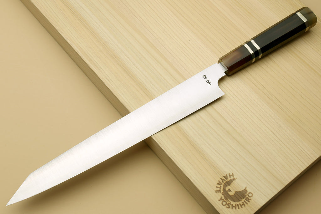 Sujihiki-kiritsuke slicer knife angled view with stainless blade and wooden handle