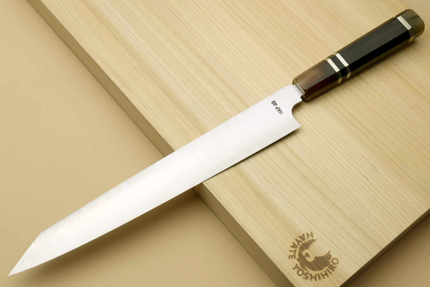 Sujihiki-kiritsuke slicer knife angled view with stainless blade and wooden handle