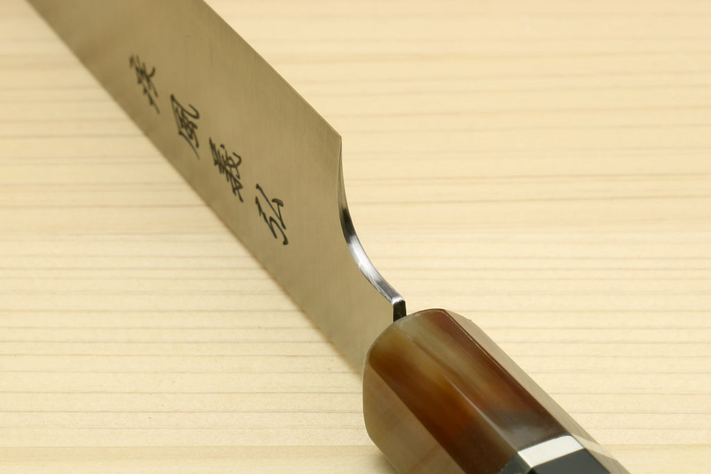 Sujihiki-kiritsuke knife close-up with engraved blade heel and dark wooden grip