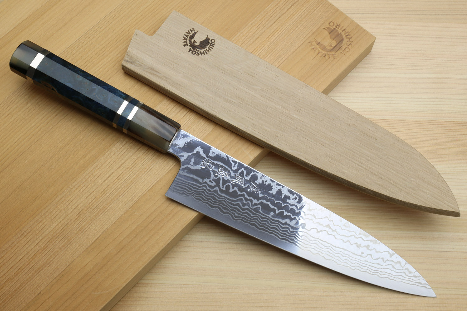 Gyuto chef knife with damascus blade, ocean blue handle, and matching wooden sheath