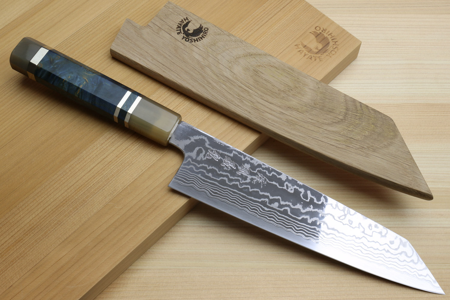 Damascus kiritsuke chefs knife with ocean blue handle and sharp pointed blade