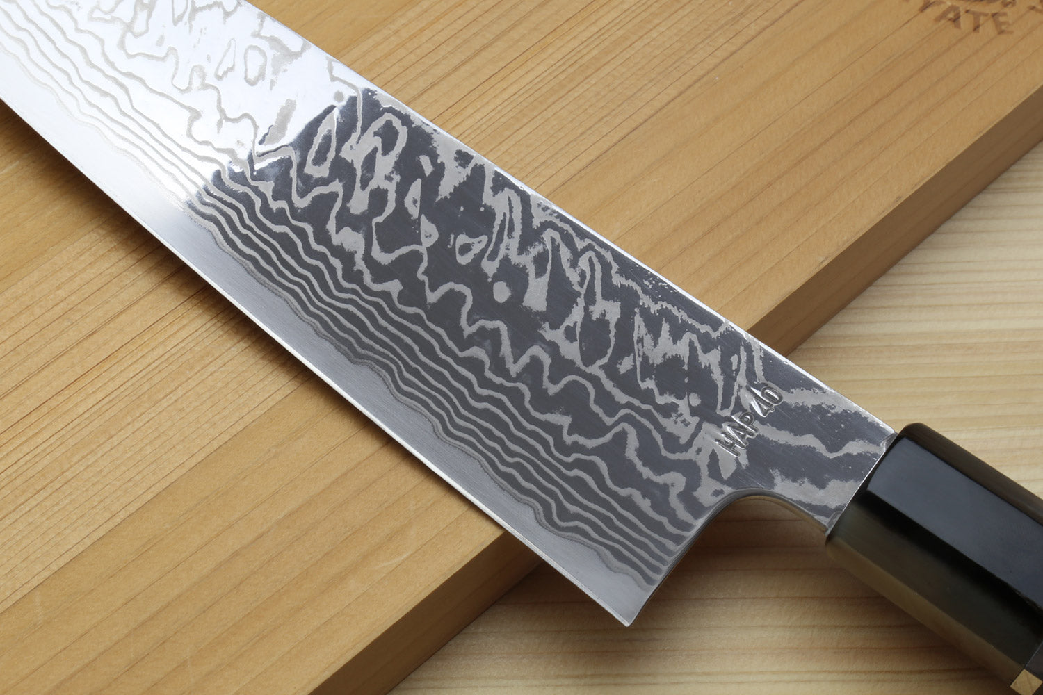 Damascus blade close view on kiritsuke chefs knife with ocean blue handle