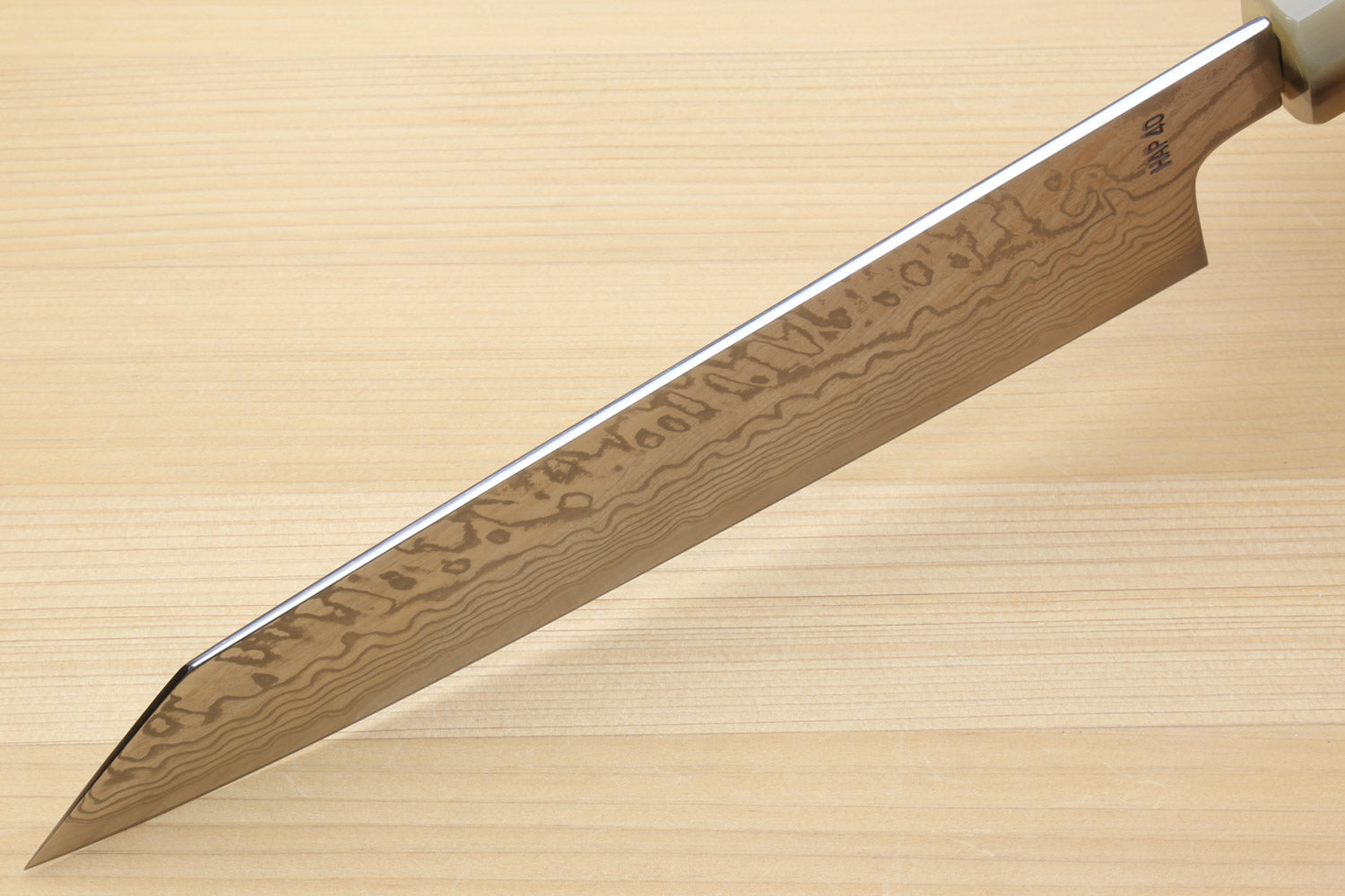 Damascus kiritsuke chefs knife side profile with pointed tip and wooden grip