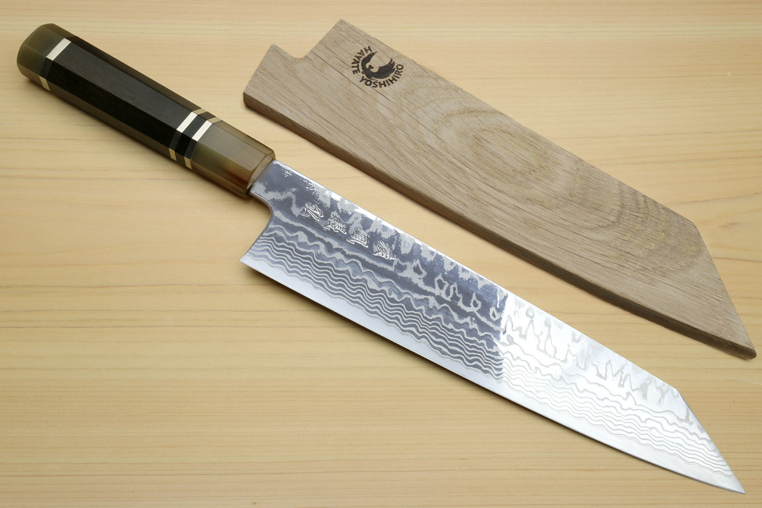 Kiritsuke chef's knife and wooden saya, ebony handle with wavy damascus blade