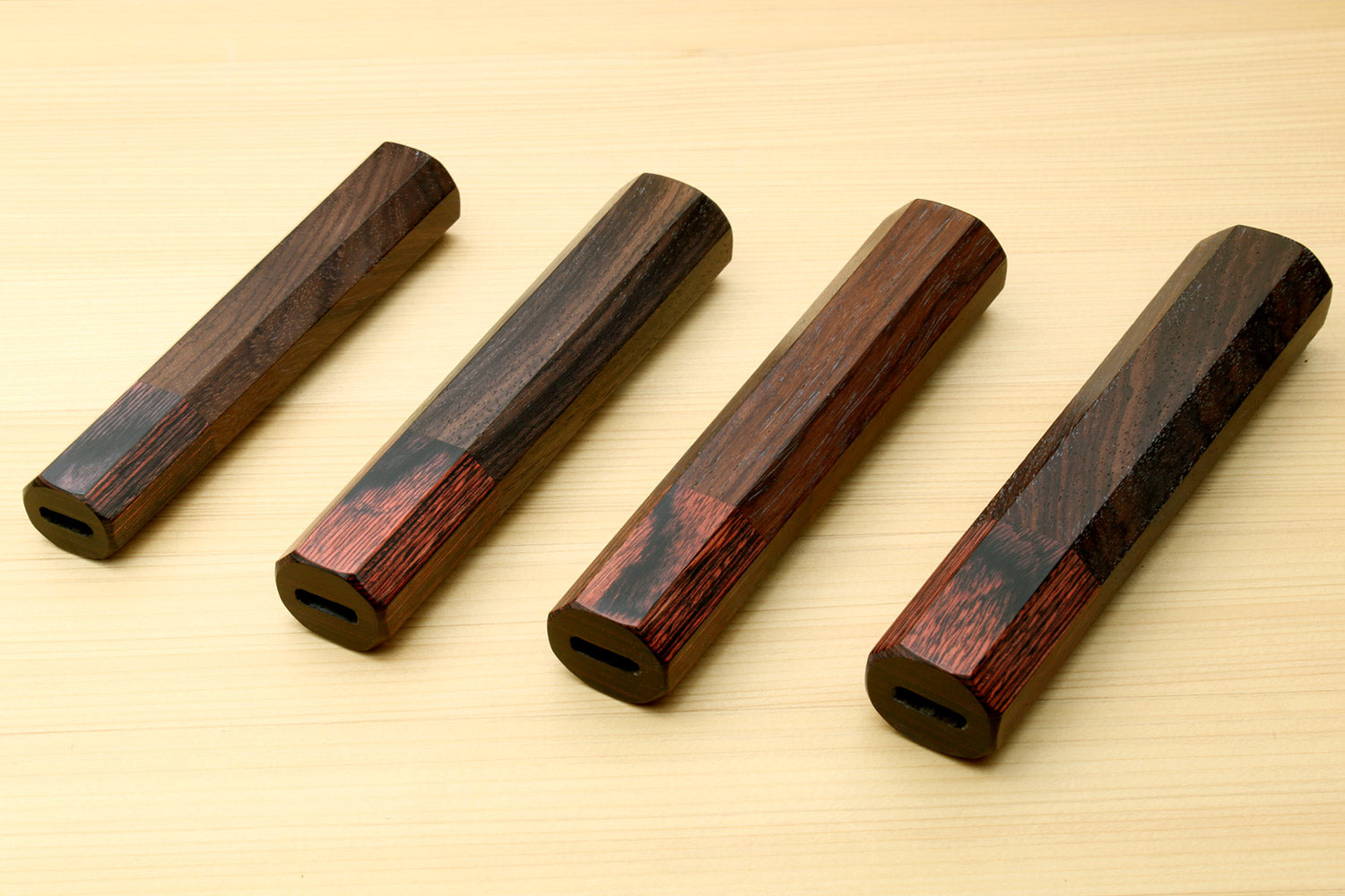 Four rosewood handle blanks with mahogany bolsters, end lanyard holes