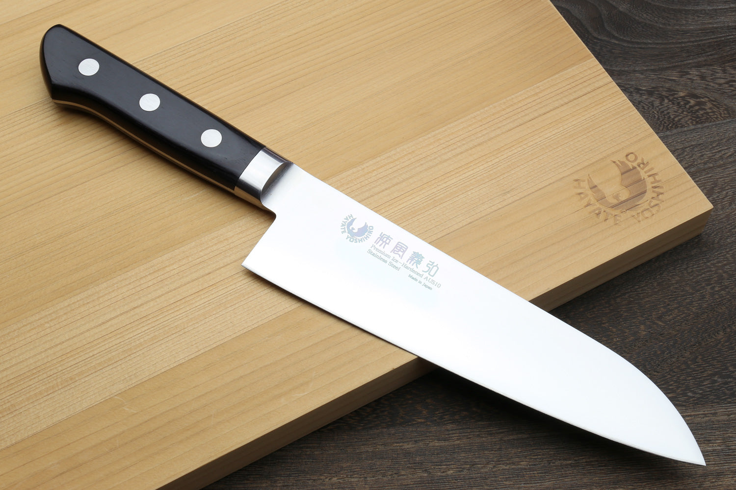 Santoku chef’s knife with stainless blade and black handle with white dot accents