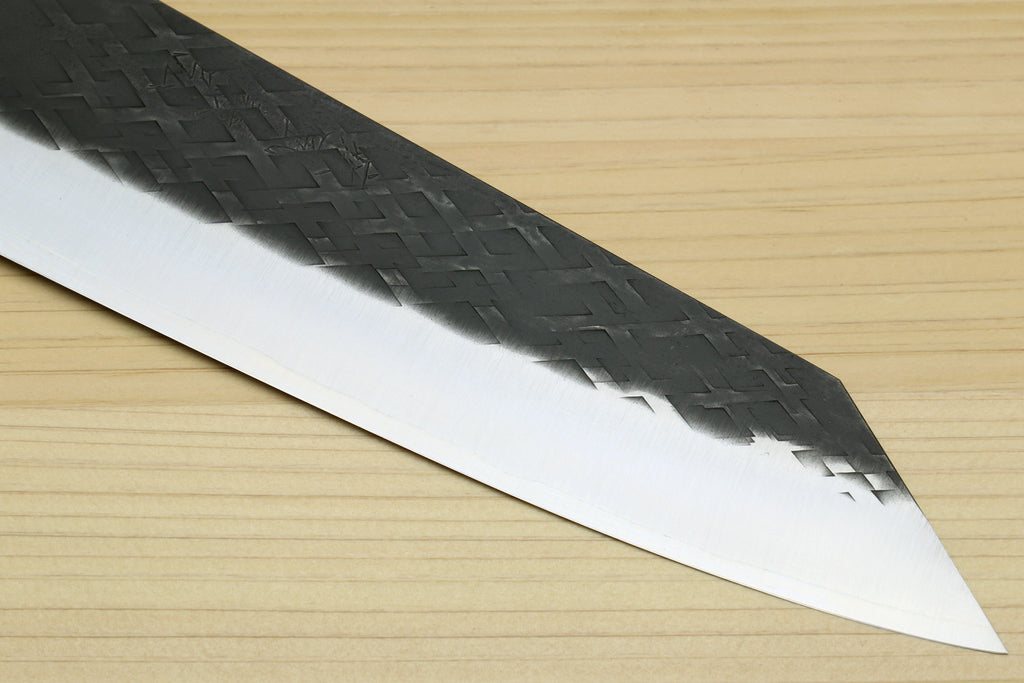 Kiritsuke chef knife blade close-up, textured dark pattern and silver edge