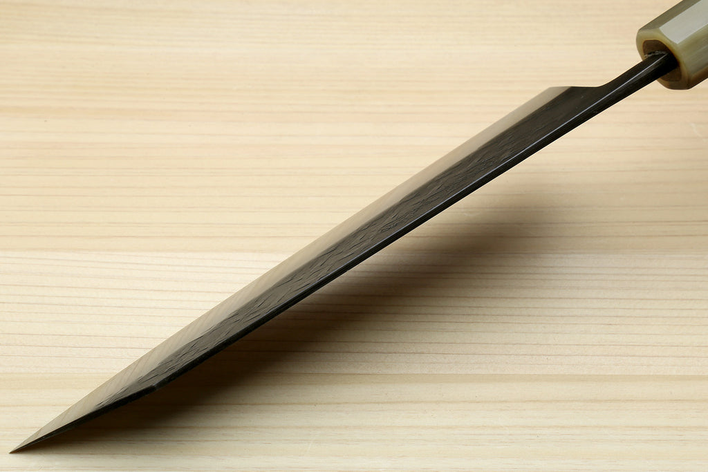 Kiritsuke chef knife blade with dark handle, pointed tip and silver cutting edge