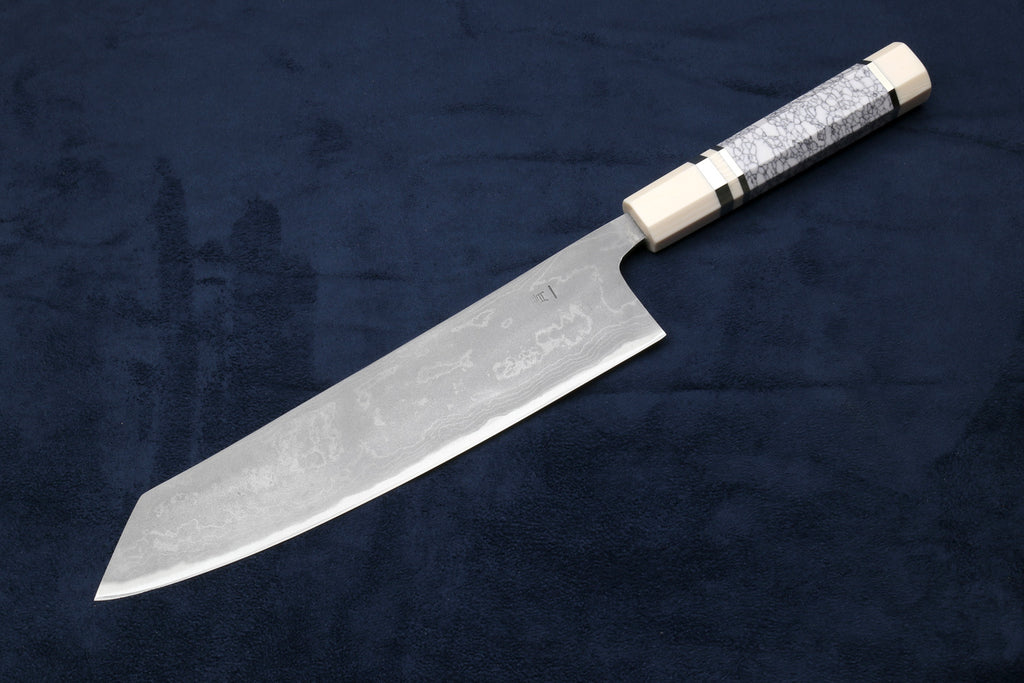 Japanese chef knife with silver damascus blade and white handle with dark band