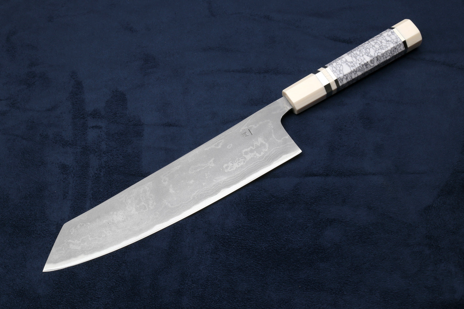 Japanese chef knife with silver damascus blade and white handle with dark band