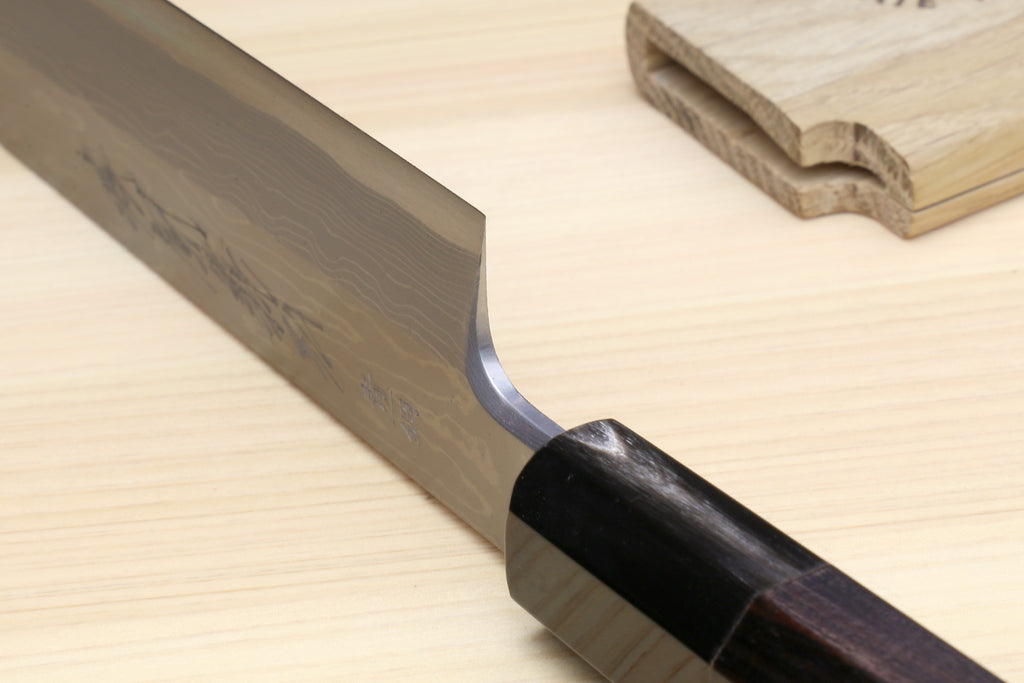 Yanagi sushi knife with ebony handle and dark steel blade edge close-up