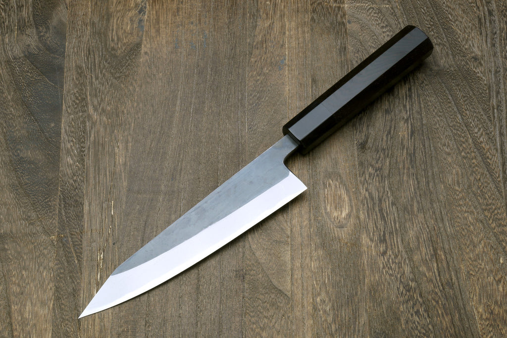 Petty-kiritsuke knife with dark blade and ebony wood handle, pointed tip