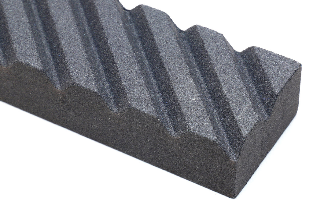 Sharpening stone fixer, black textured ridged surface in close view