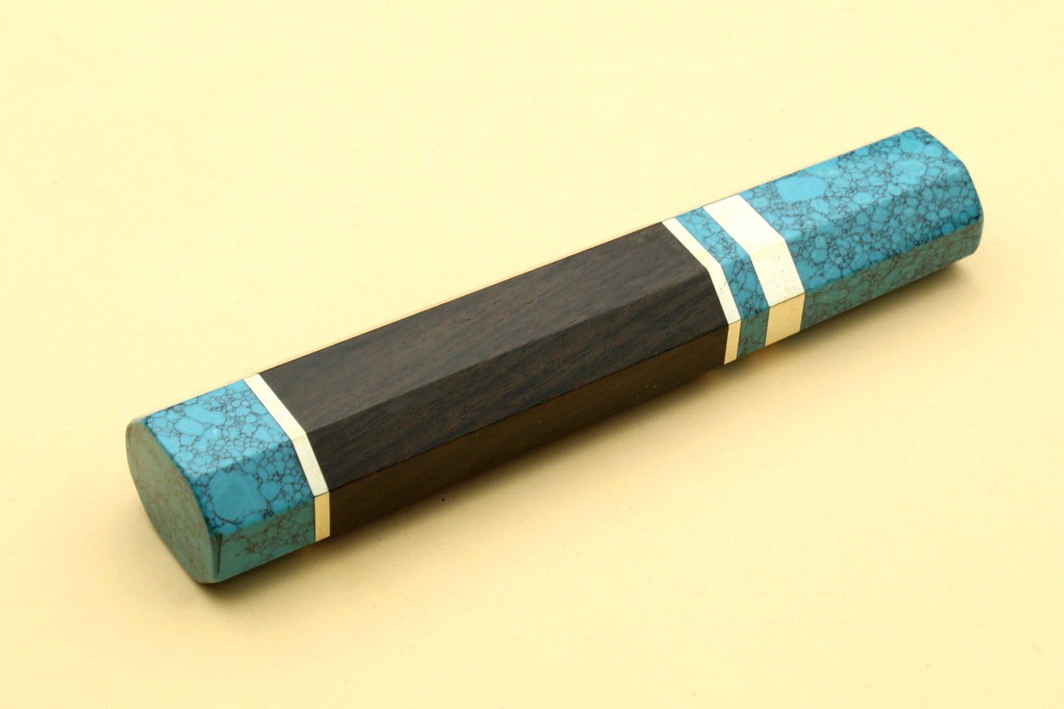 Turquoise blue knife handle with dark wood body and white stripe accents