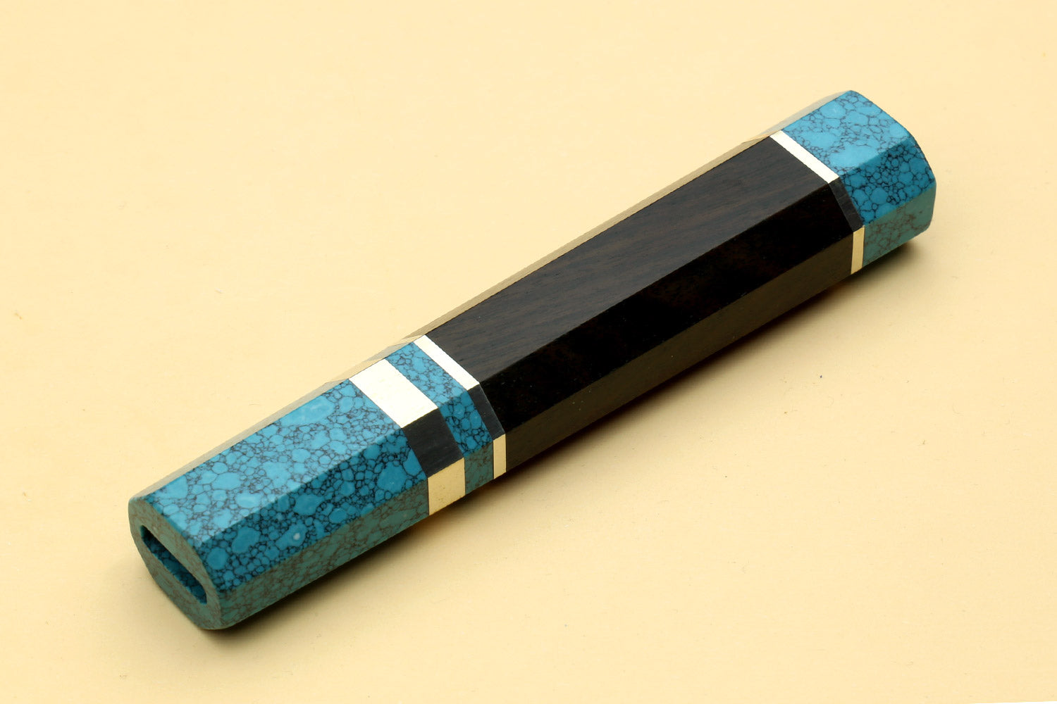 Turquoise blue knife handle with dark wood, white stripe rings, and end cap