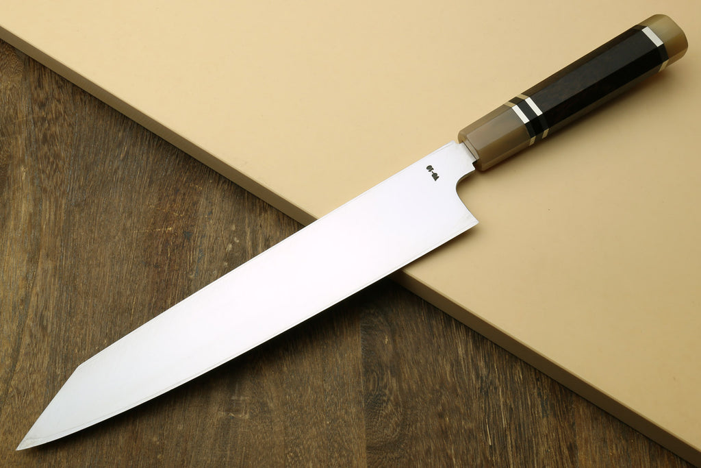 Kiritsuke Japanese knife with mirror-finished blade and dark handle, edge view