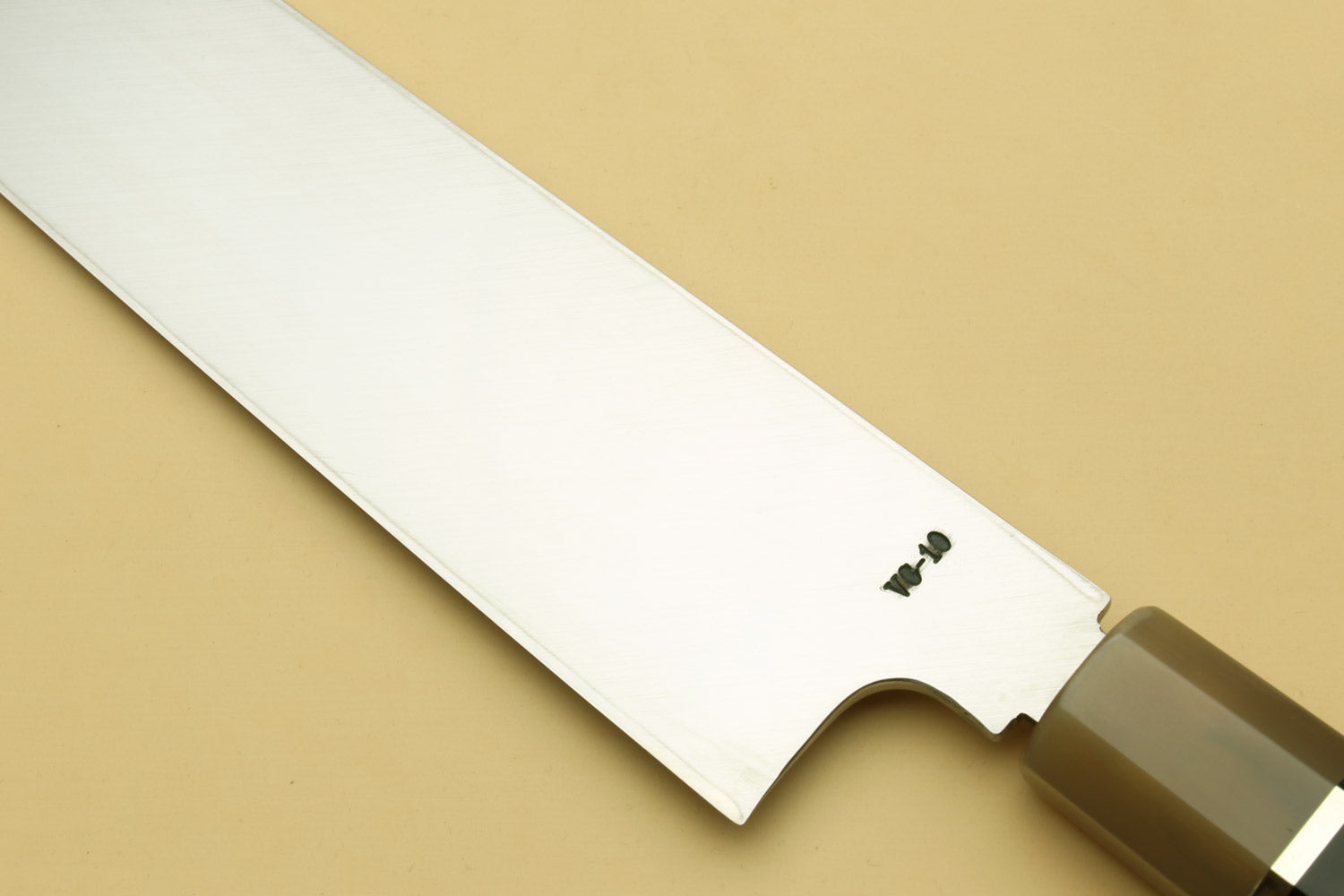 Kiritsuke Japanese knife with single-edge blade and dark handle with triple rings