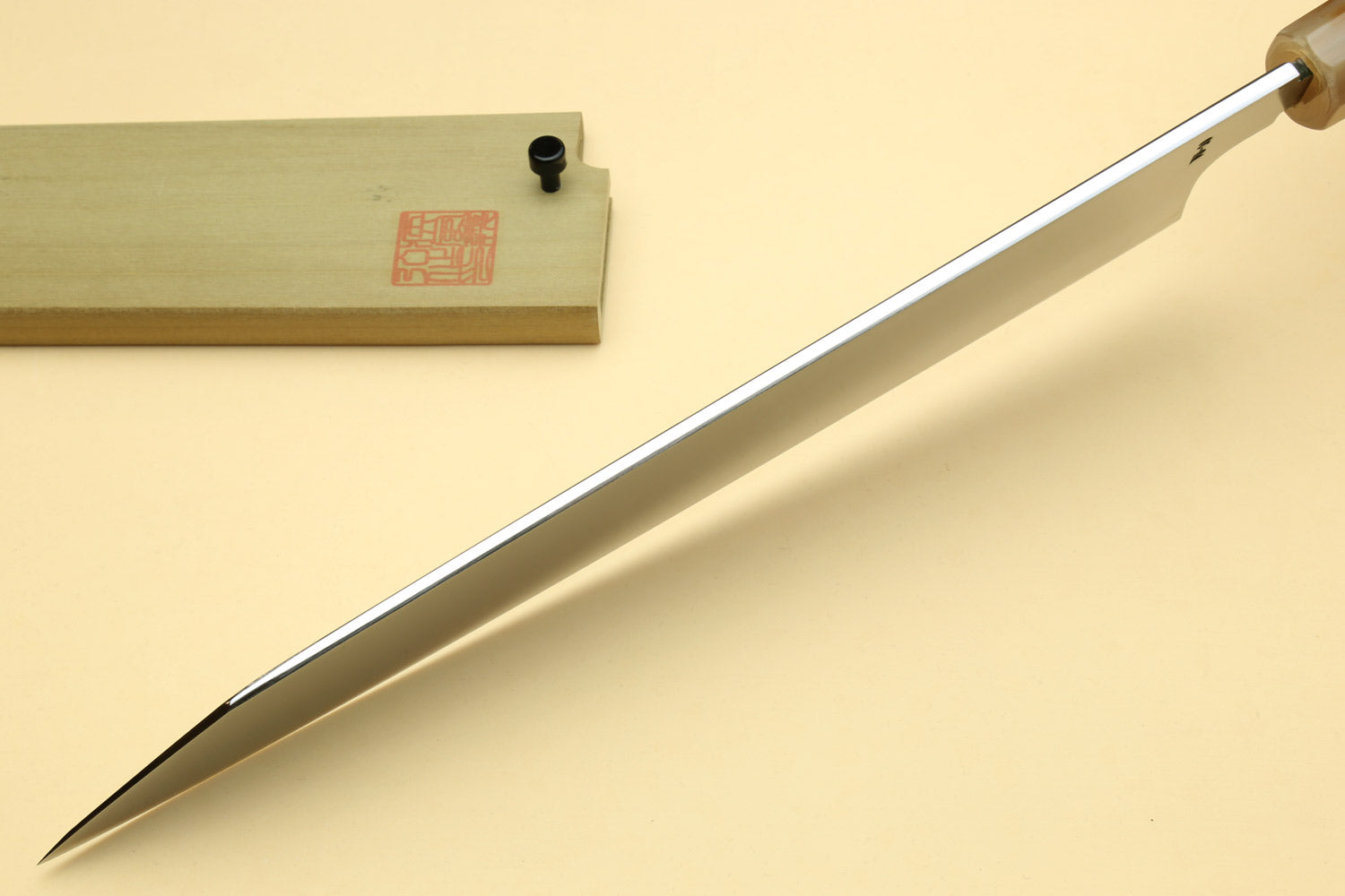 Kiritsuke Japanese knife with pointed tip, mirror blade, dark handle