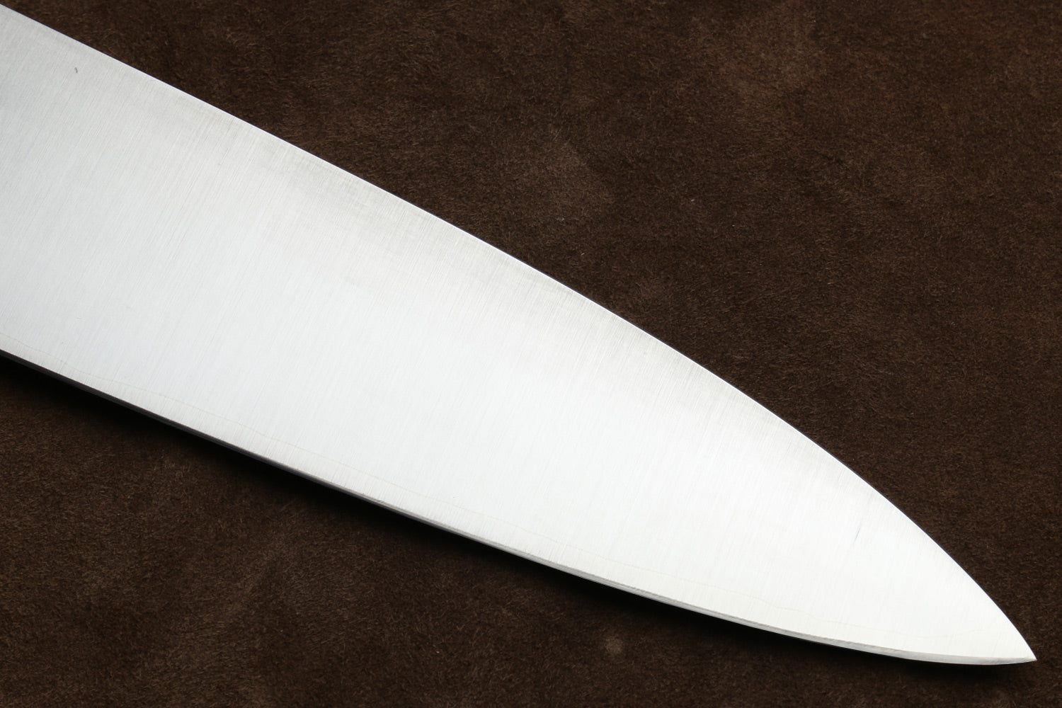 Stainless gyuto knife blade edge close-up, smooth satin finish