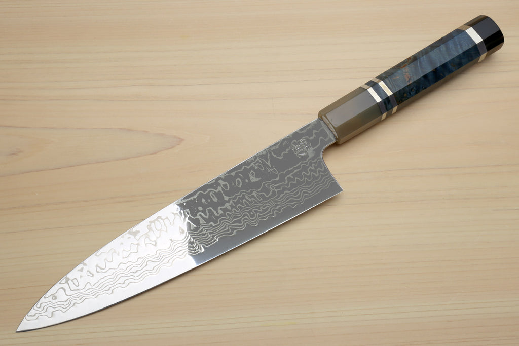 Chef gyuto knife with blue octagonal handle and Damascus steel blade, angled side view