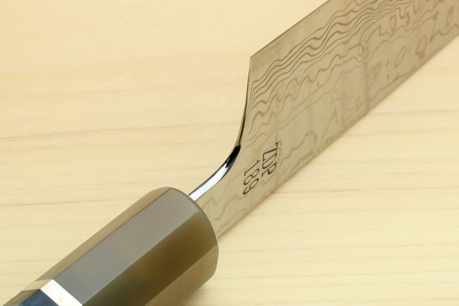 Chef gyuto knife close-up of Damascus blade and ocean blue octagonal handle