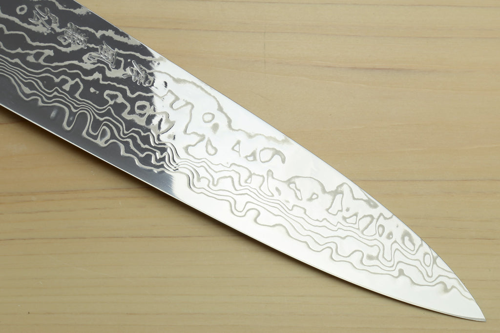 Chef gyuto knife close-up of Damascus blade with pale edge and ocean blue handle end