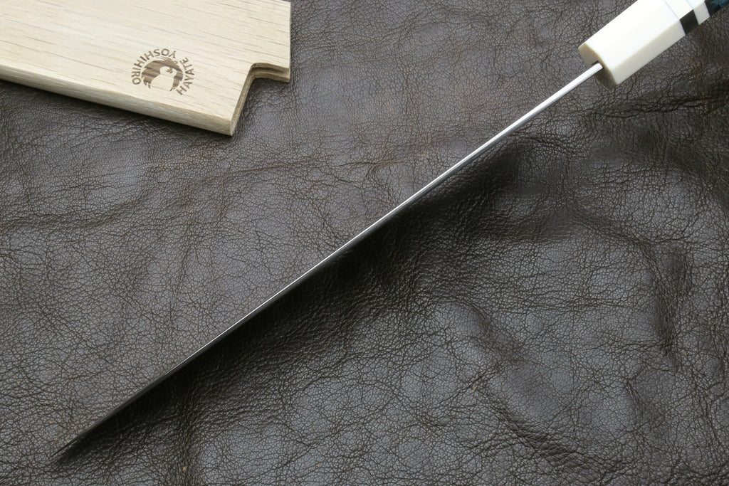 Damascus gyuto chef knife with silver-toned blade and ivory octagonal handle, side view
