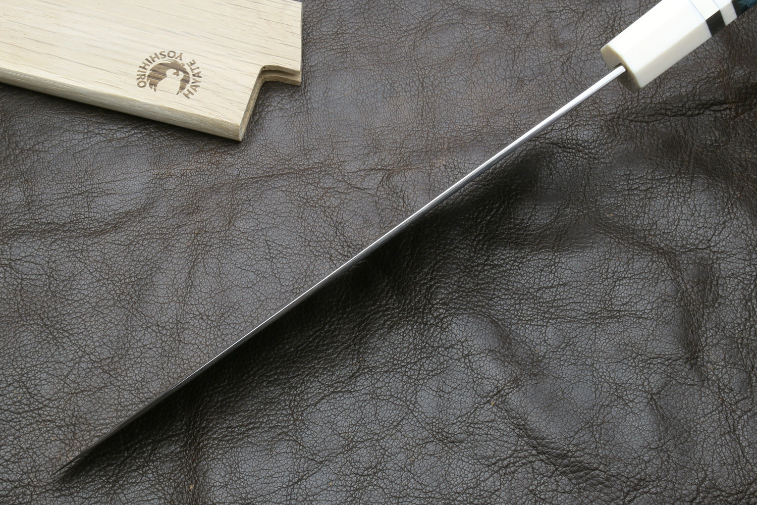Damascus gyuto chef knife with silver-toned blade and ivory octagonal handle, side view
