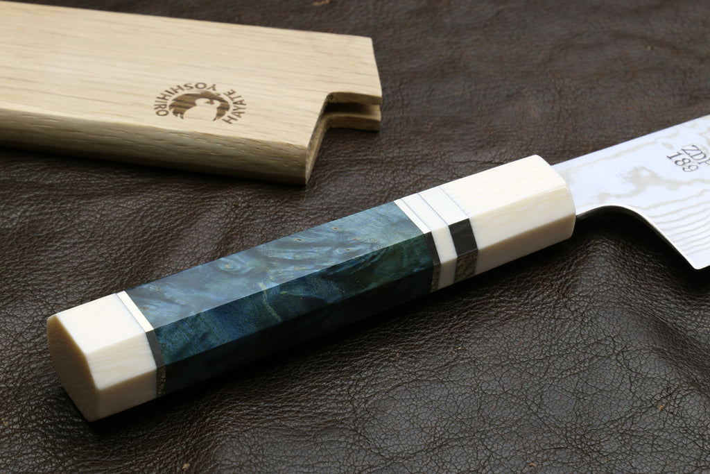 Damascus gyuto chef knife with ivory handle scales and teal bolster, bolster-close view