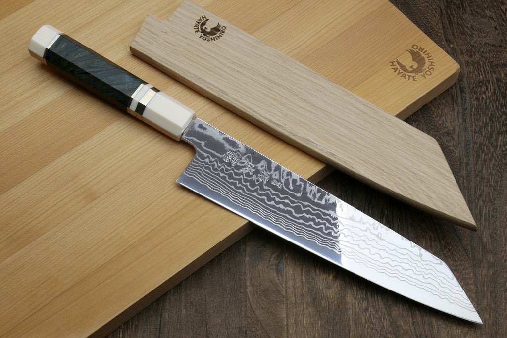 Kiritsuke chef knife set on boards: dark handle with white bolster, Damascus blade