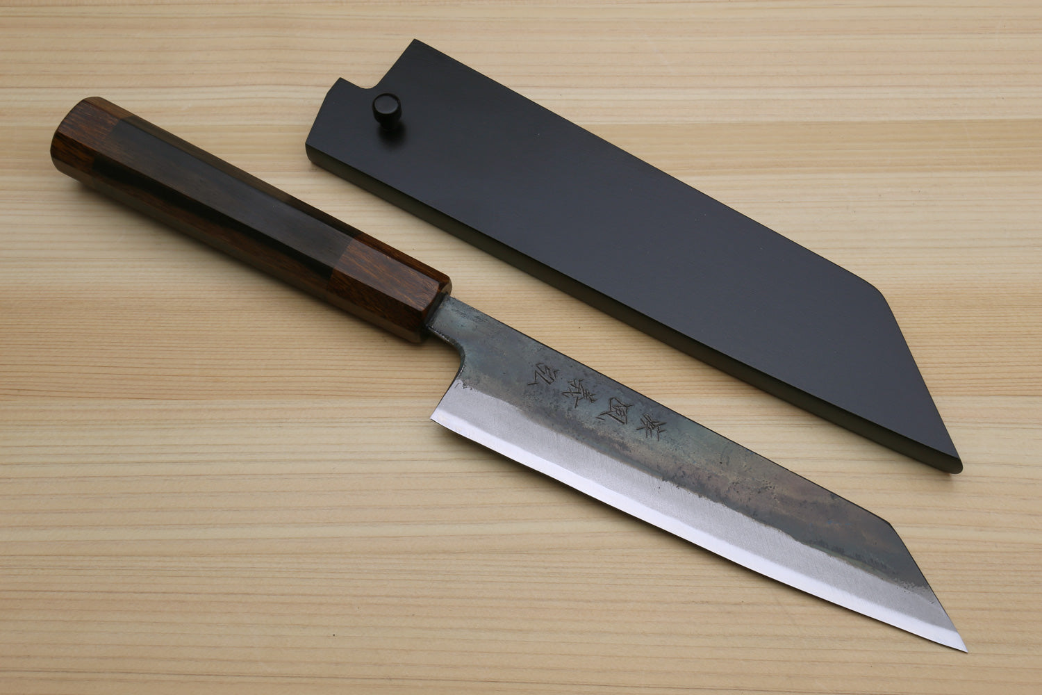 Japanese utility knife with black saya cover, kurouchi blade, and ebony handle