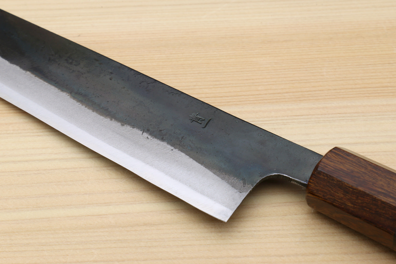 Japanese utility knife with kurouchi blade, edge view, and ebony handle