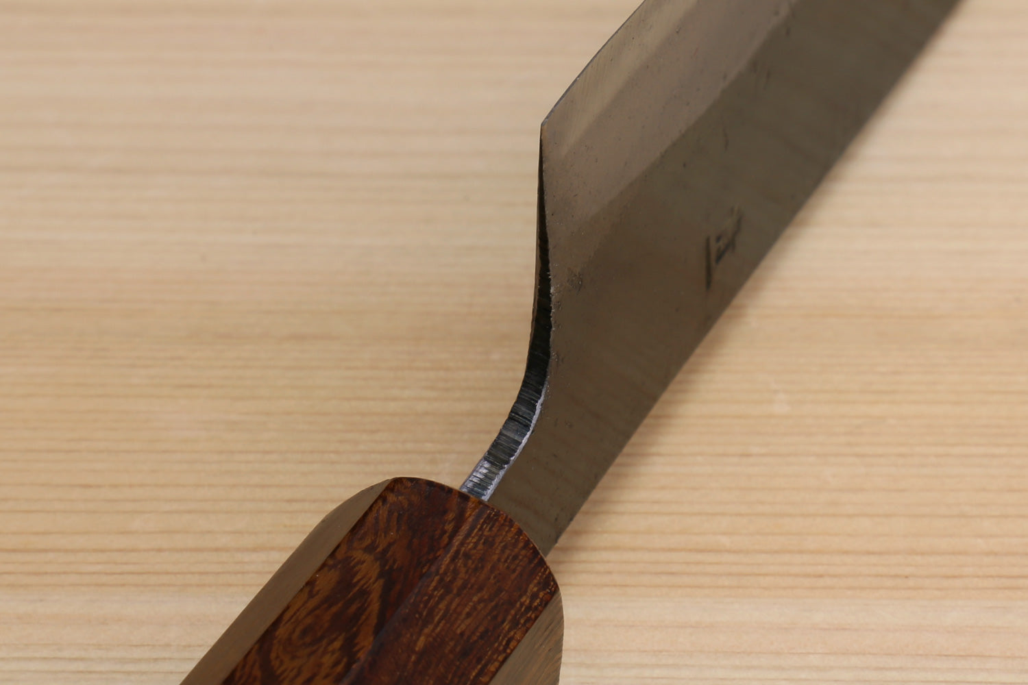 Knife back and tang area with kurouchi blade and ebony handle
