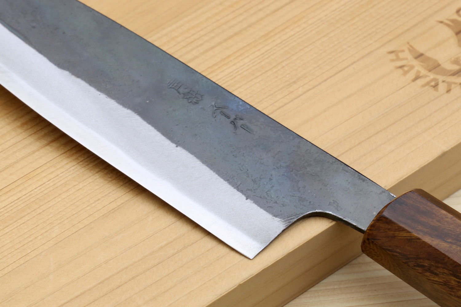 Petty utility knife blade edge with kurouchi finish and dark ebony handle, side view