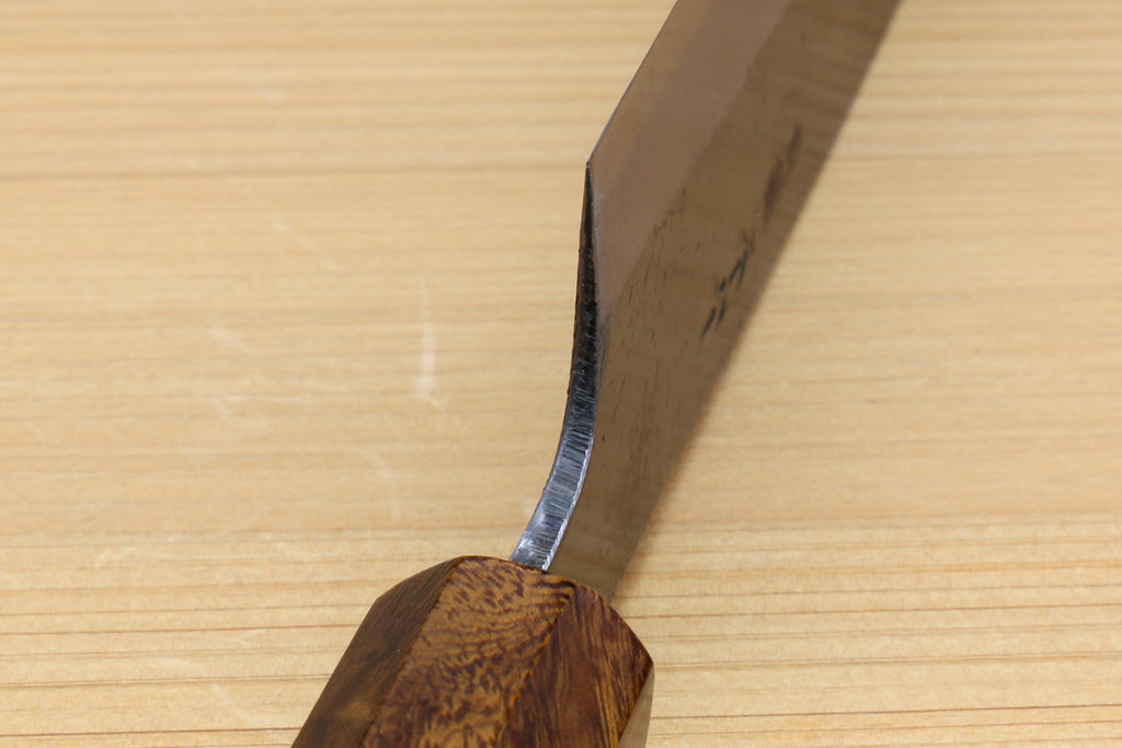 Petty utility knife handle close-up with dark ebony wood and curved knife spine