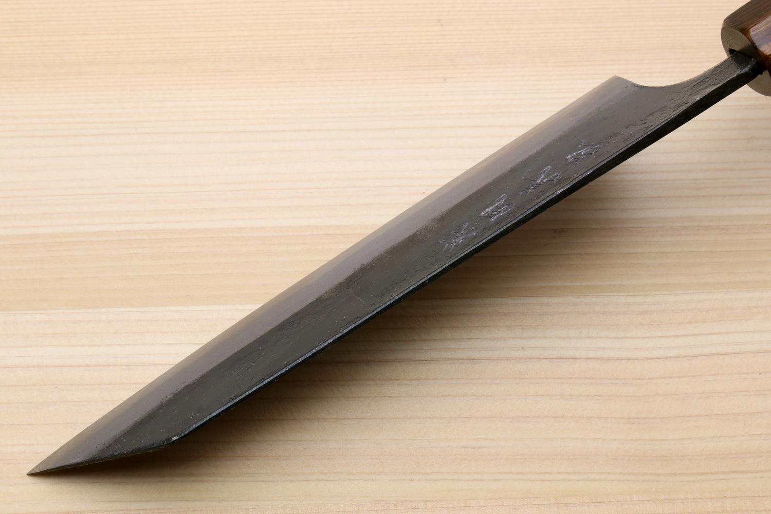 Utility knife blade side view with dark finish and tapered point