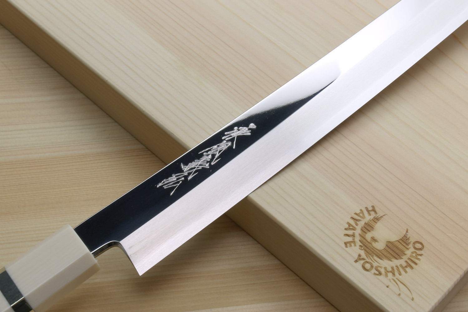 Sakimaru sushi slicer knife side view with mirror-polished steel blade and dark blue handle