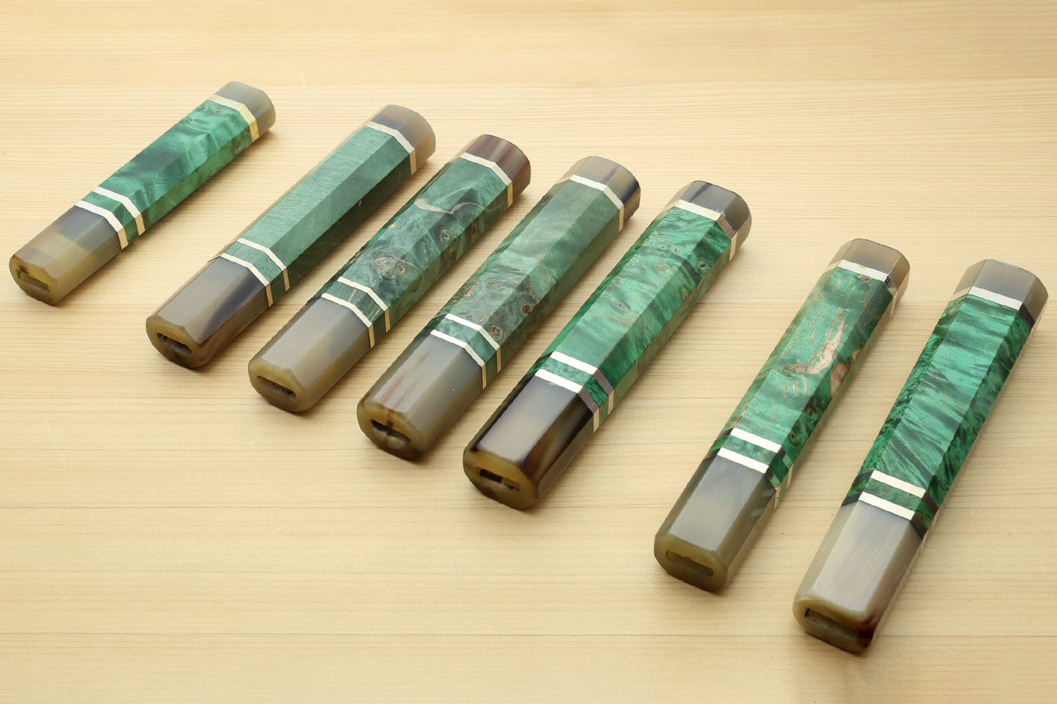 Assorted green burl knife handles with horn bolsters and white striped collar bands