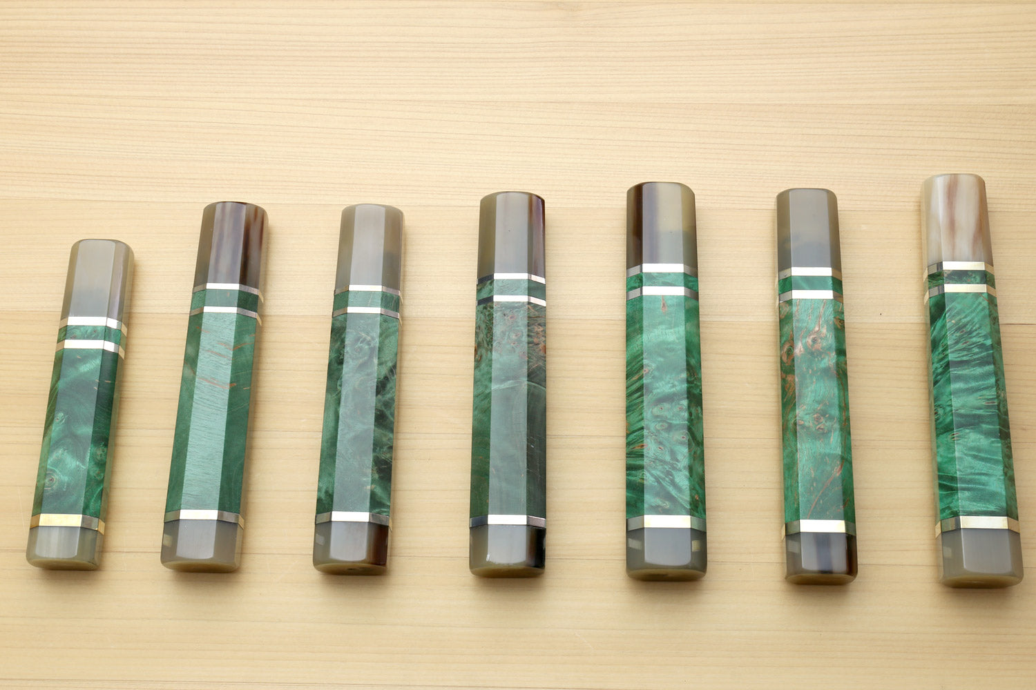 Set of green stabilized burl knife handles with horn bolsters and white striped collars