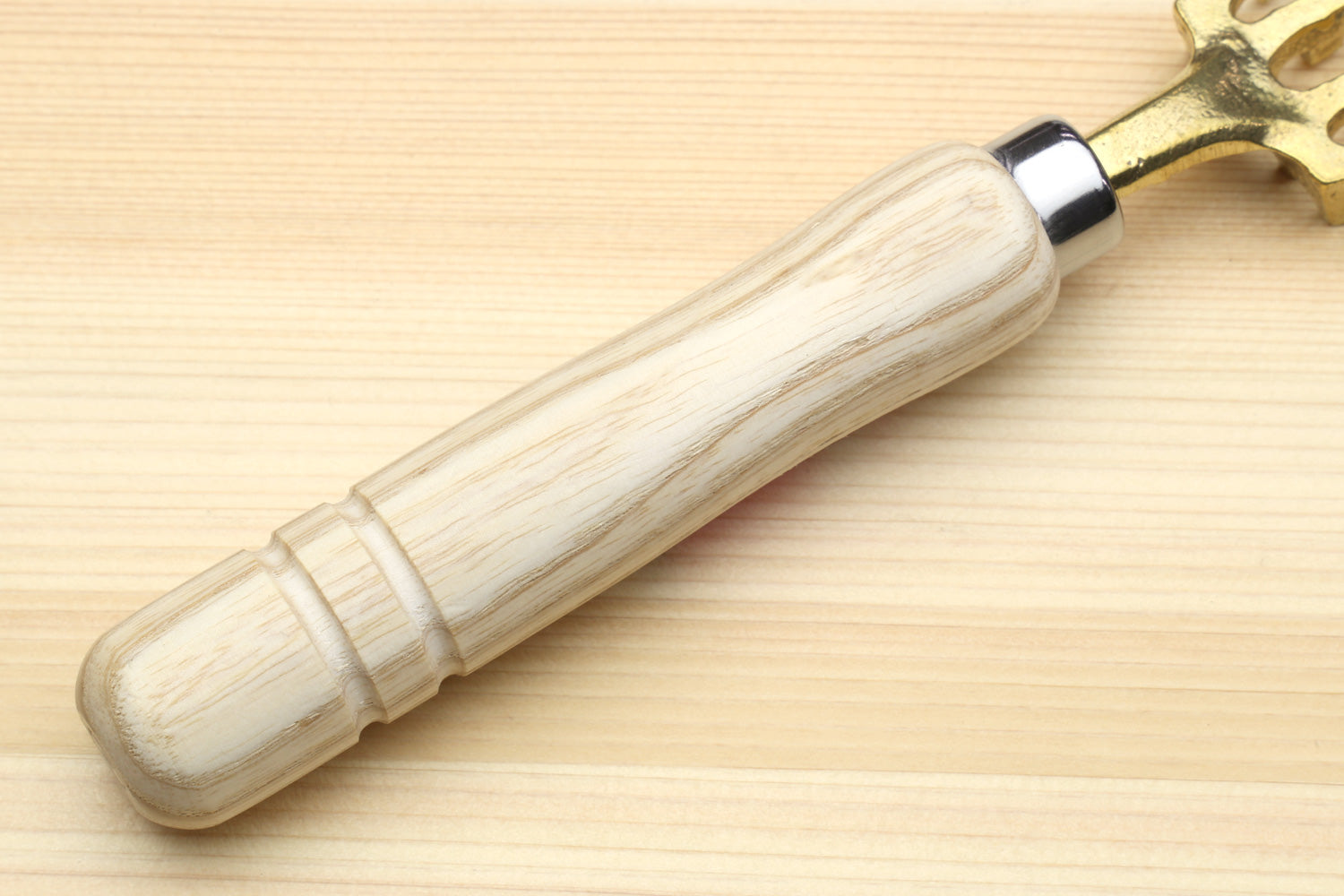 Large fish scaler tool light wood handle with chrome collar and gold-toned head